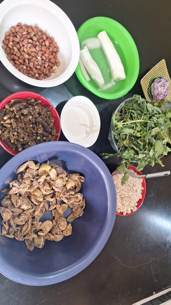 A traditional Zambian spread of ingredients including ifinkubala, lumanda, groundnuts, mealie meal and cassava