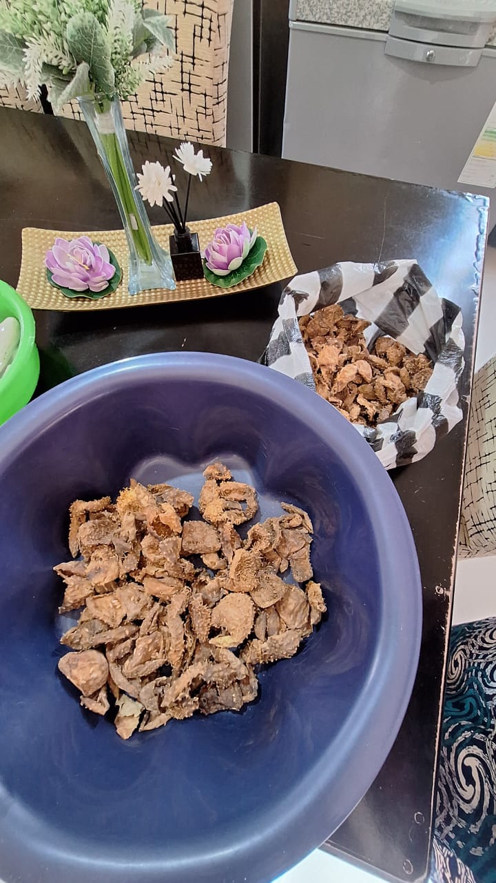Dried ifinkubala being sorted from packaging into a bowl